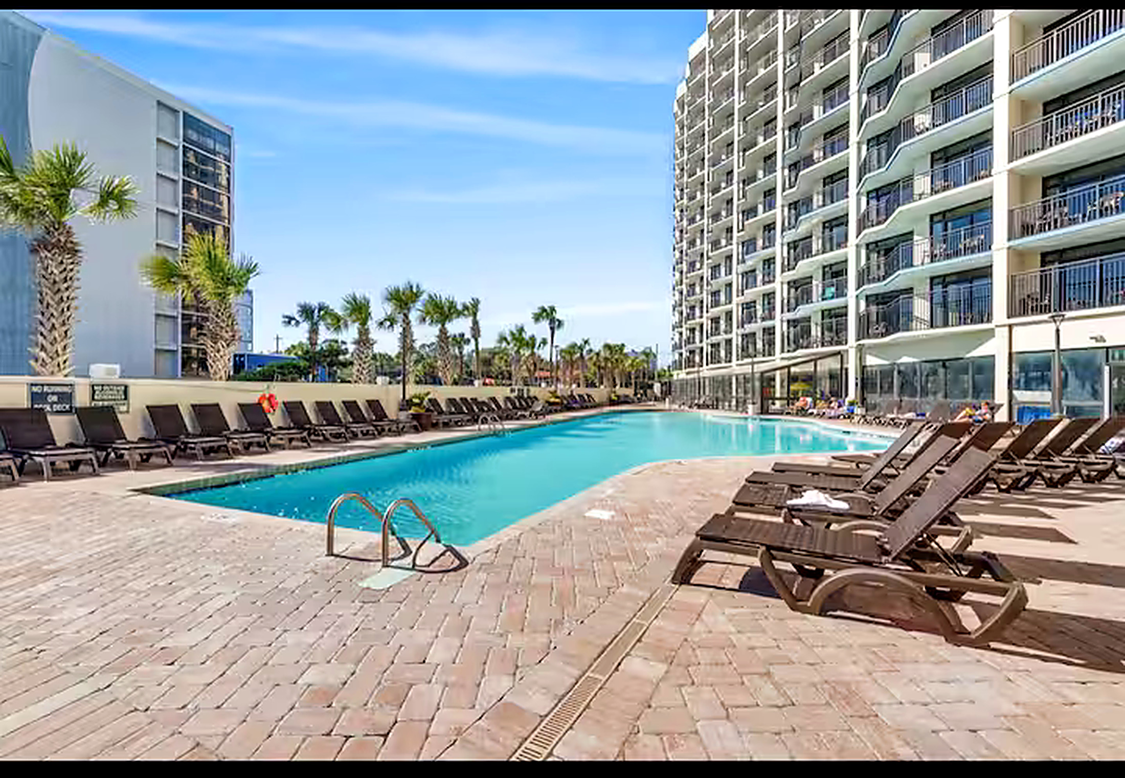 Oceanfront resort pool deck with loungers
